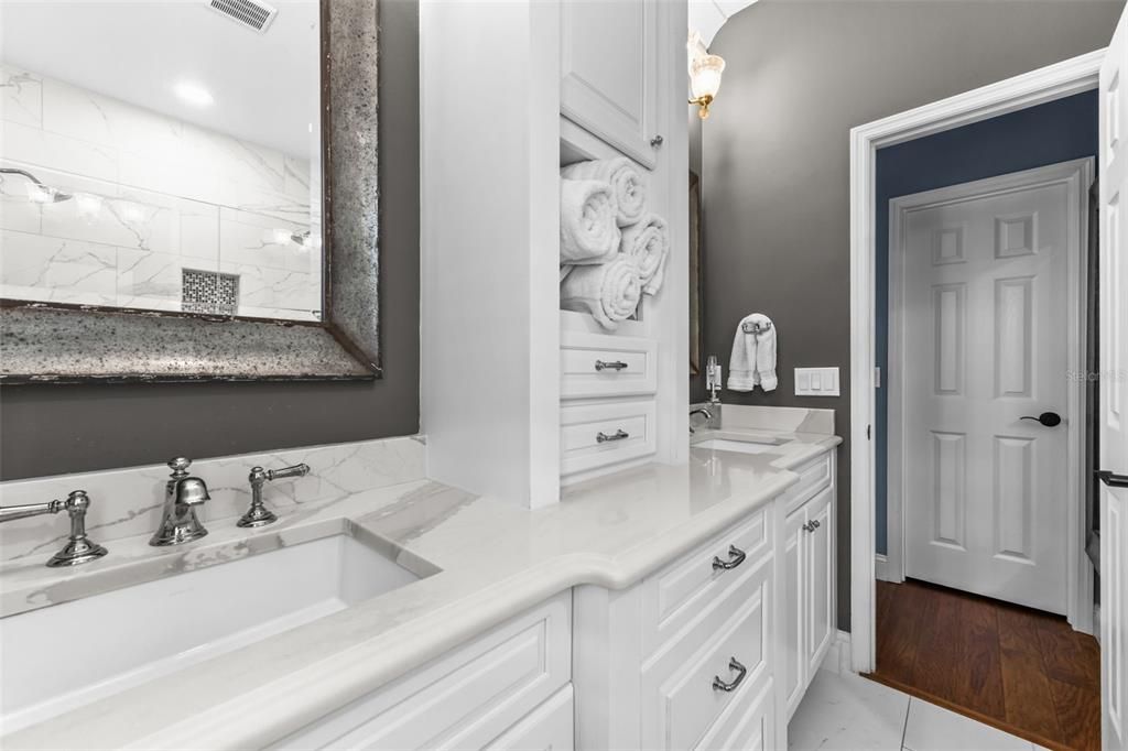 Bathroom, Dual Sink Vanities, Interior, Marble Walls, Recessed Lighting, Wood Texture Flooring