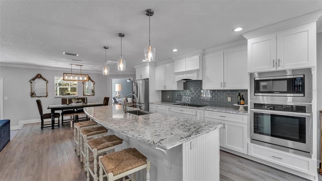 Dining room, Interior, Kitchen, Pendant Lights, Recessed Lighting, Stainless Steel Appliances, Wood Texture Flooring
