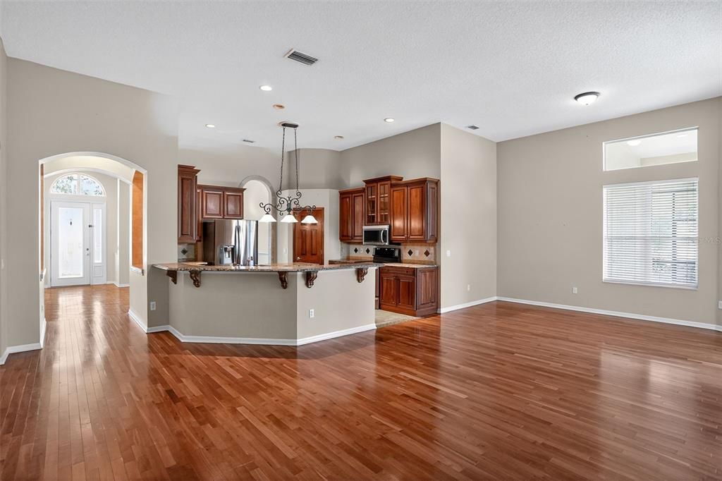 Empty room, Interior, Kitchen, Pendant Lights, Recessed Lighting, Stainless Steel Appliances, Wood Texture Flooring