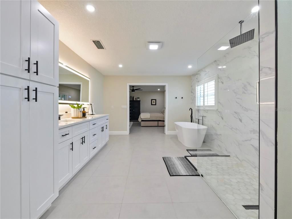 Bathroom, Dual Sink Vanities, Free Standing Baths, Glass Shower, Interior, Marble Walls, Recessed Lighting