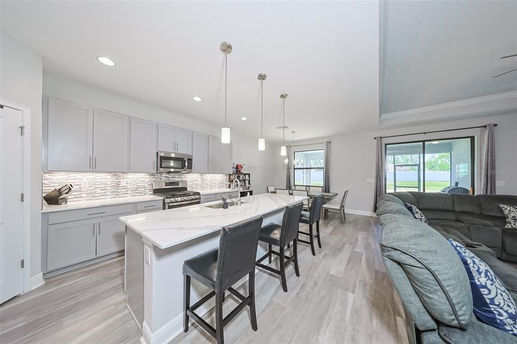 Dining room, Interior, Kitchen, Living room, Pendant Lights, Recessed Lighting, Stainless Steel Appliances, Wood Texture Flooring