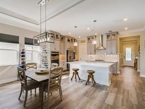 Chandelier, Dining room, Interior, Kitchen, Pendant Lights, Recessed Lighting, Stainless Steel Appliances, Wood Texture Flooring