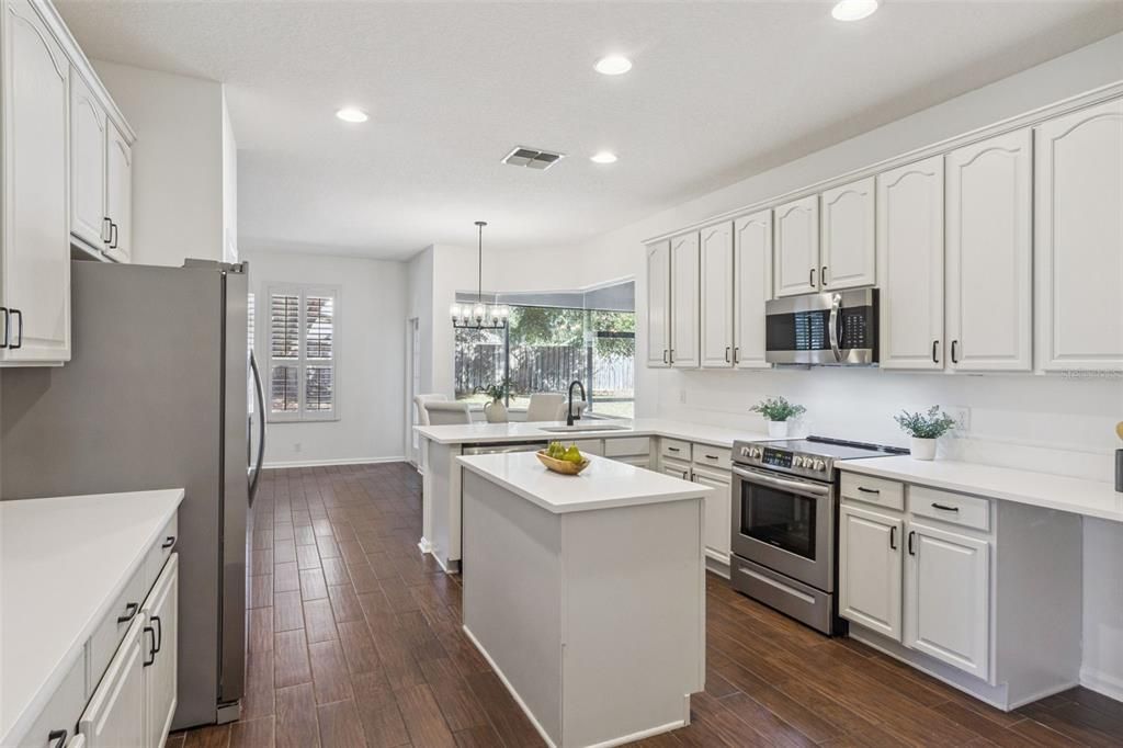 Chandelier, Dining room, Interior, Kitchen, Pendant Lights, Recessed Lighting, Stainless Steel Appliances, Wood Texture Flooring