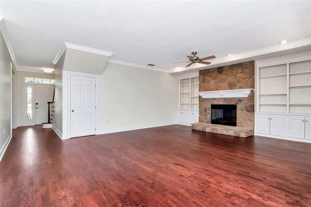 Empty room, Fireplace, Interior, Recessed Lighting, Stone Walls, Wood Texture Flooring