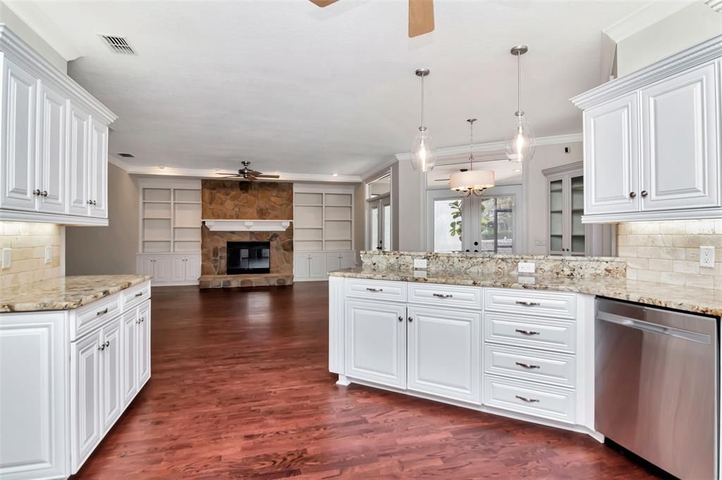 Fireplace, Interior, Kitchen, Pendant Lights, Recessed Lighting, Stainless Steel Appliances, Stone Walls, Wood Texture Flooring