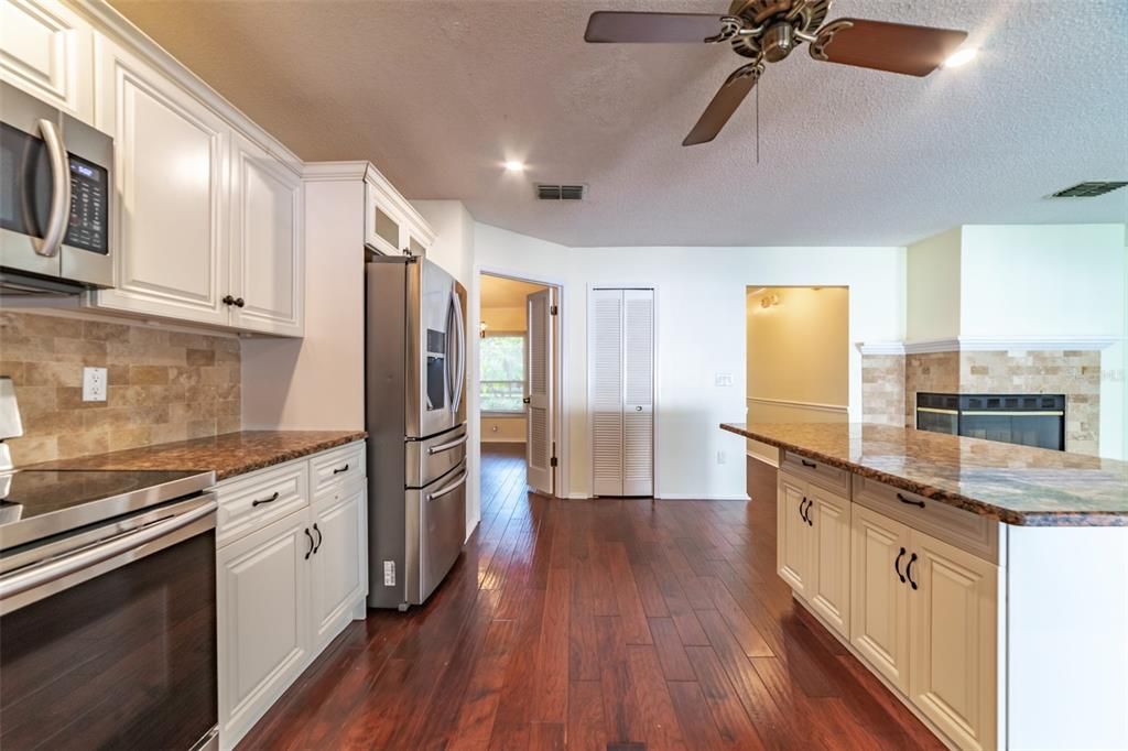 Fireplace, Interior, Kitchen, Recessed Lighting, Stainless Steel Appliances, Wood Texture Flooring