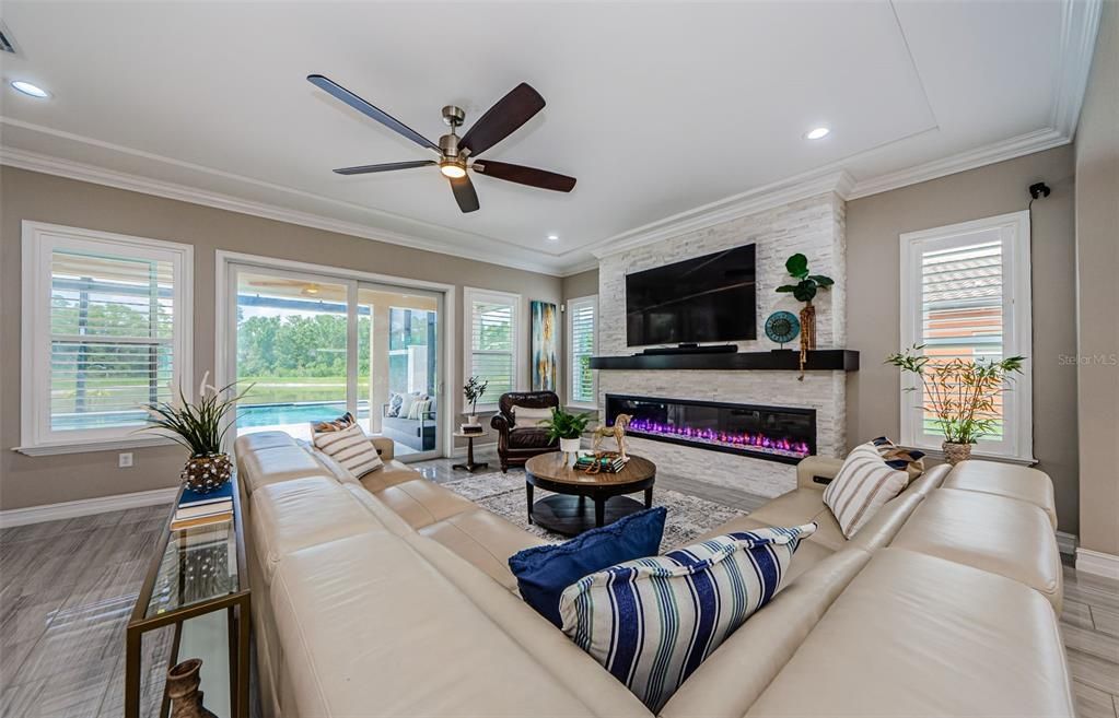 Fireplace, Interior, Living room, Recessed Lighting, Stone Walls, Wood Texture Flooring