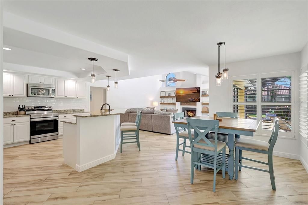 Dining room, Fireplace, Interior, Kitchen, Living room, Pendant Lights, Recessed Lighting, Stainless Steel Appliances, Wood Texture Flooring