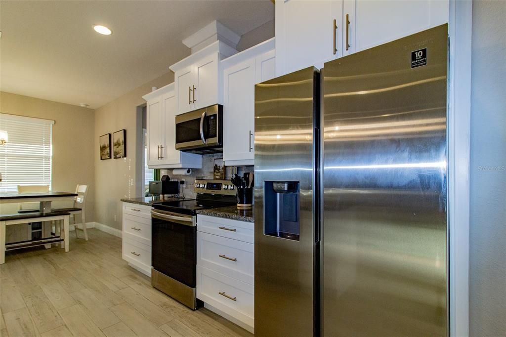 Dining room, Interior, Kitchen, Recessed Lighting, Stainless Steel Appliances, Wood Texture Flooring