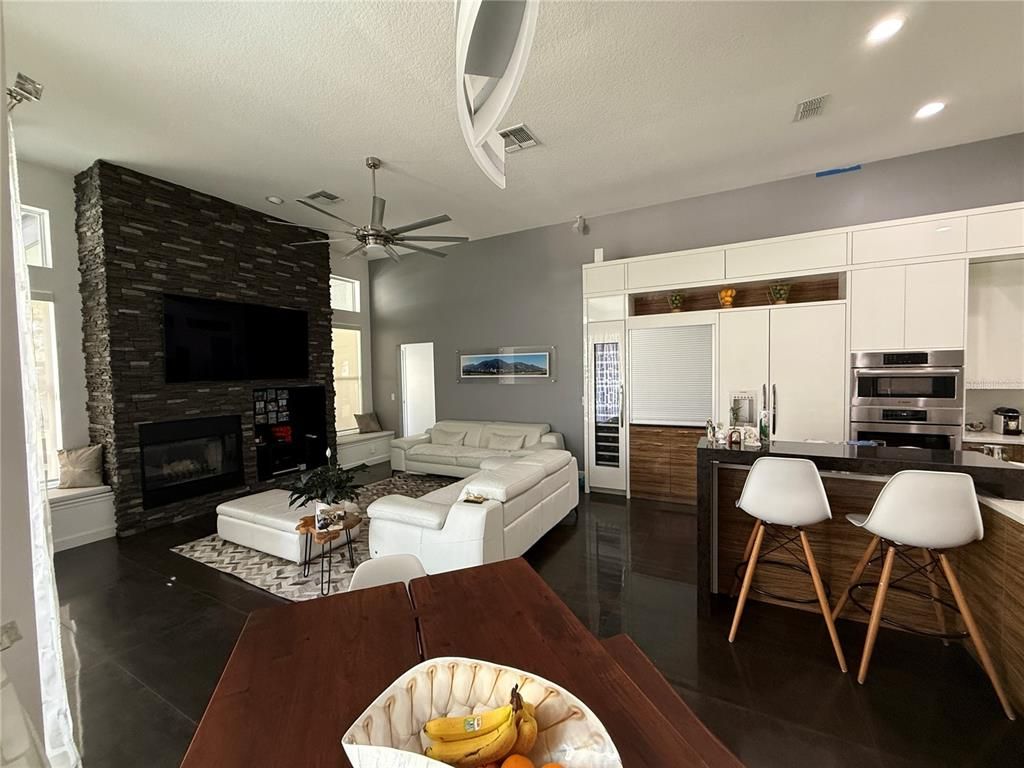 Fireplace, Interior, Kitchen, Living room, Recessed Lighting, Stainless Steel Appliances, Stone Walls
