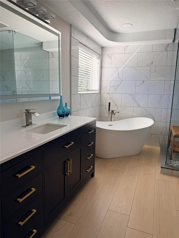 Bathroom, Dual Sink Vanities, Free Standing Baths, Interior, Marble Walls, Recessed Lighting, Wood Texture Flooring