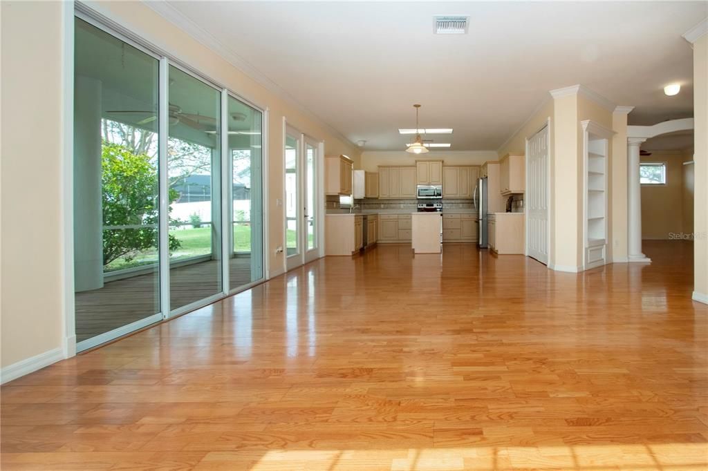 Empty room, Interior, Kitchen, Pendant Lights, Recessed Lighting, Stainless Steel Appliances, Wood Texture Flooring