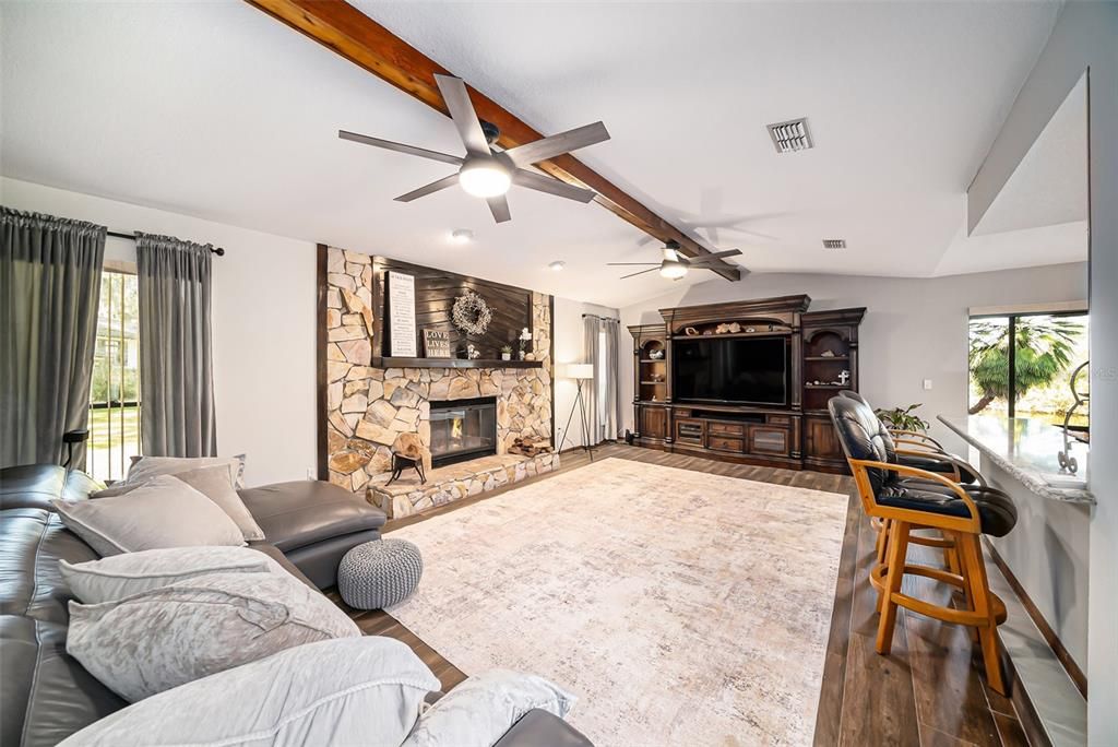 Fireplace, Interior, Living room, Recessed Lighting, Stone Walls, Wood Texture Flooring