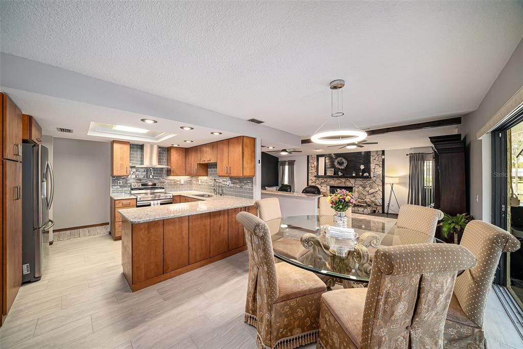 Dining room, Fireplace, Interior, Kitchen, Living room, Pendant Lights, Recessed Lighting, Stainless Steel Appliances, Wood Texture Flooring