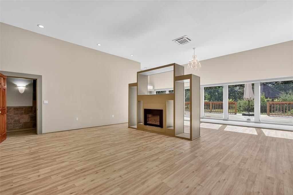 Chandelier, Empty room, Fireplace, Interior, Recessed Lighting, Wood Texture Flooring