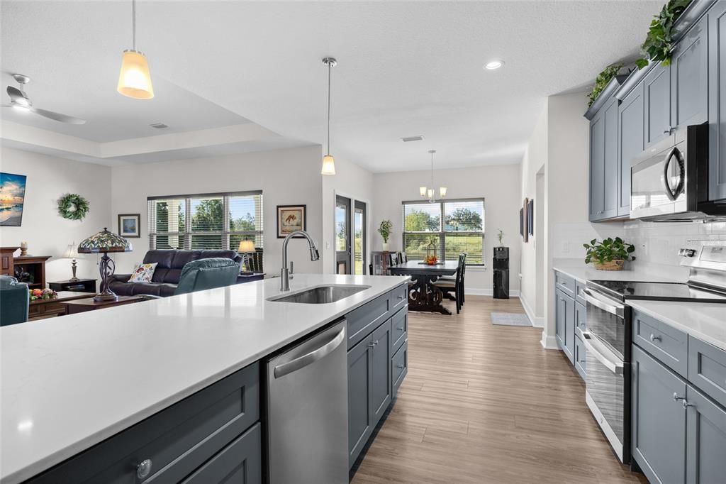 Chandelier, Dining room, Interior, Kitchen, Living room, Pendant Lights, Recessed Lighting, Stainless Steel Appliances, Wood Texture Flooring