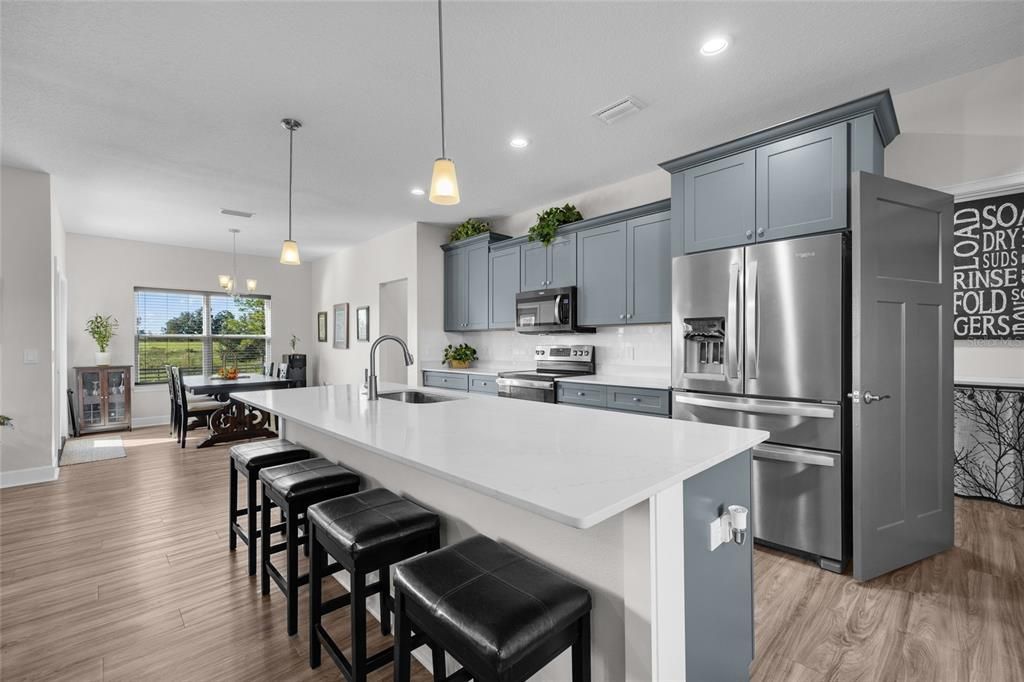 Dining room, Interior, Kitchen, Pendant Lights, Recessed Lighting, Stainless Steel Appliances, Wood Texture Flooring