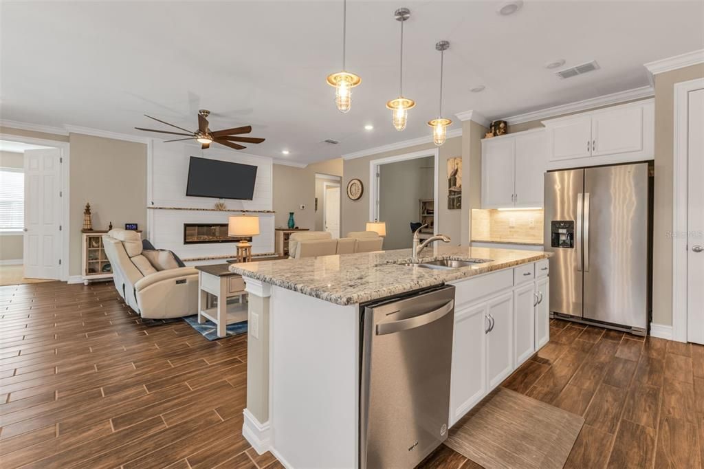 Fireplace, Interior, Kitchen, Living room, Pendant Lights, Recessed Lighting, Stainless Steel Appliances, Wood Texture Flooring