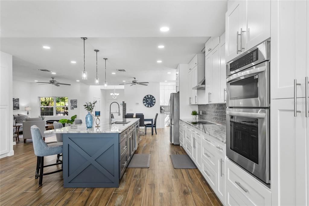 Dining room, Interior, Kitchen, Living room, Pendant Lights, Recessed Lighting, Stainless Steel Appliances, Wood Texture Flooring