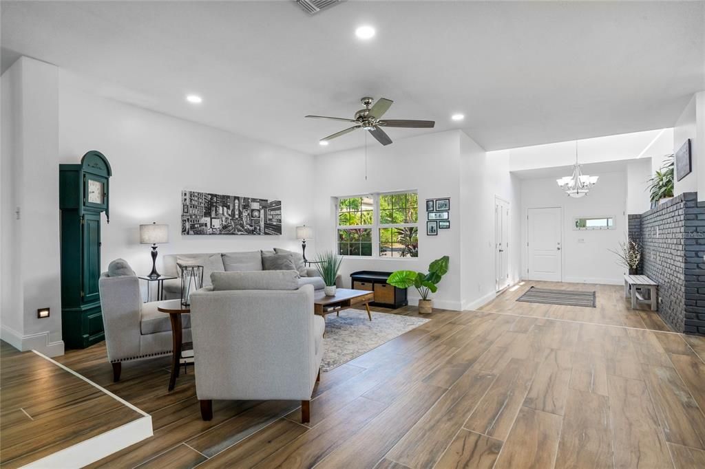 Chandelier, Fireplace, Interior, Living room, Recessed Lighting, Stone Walls, Wood Texture Flooring