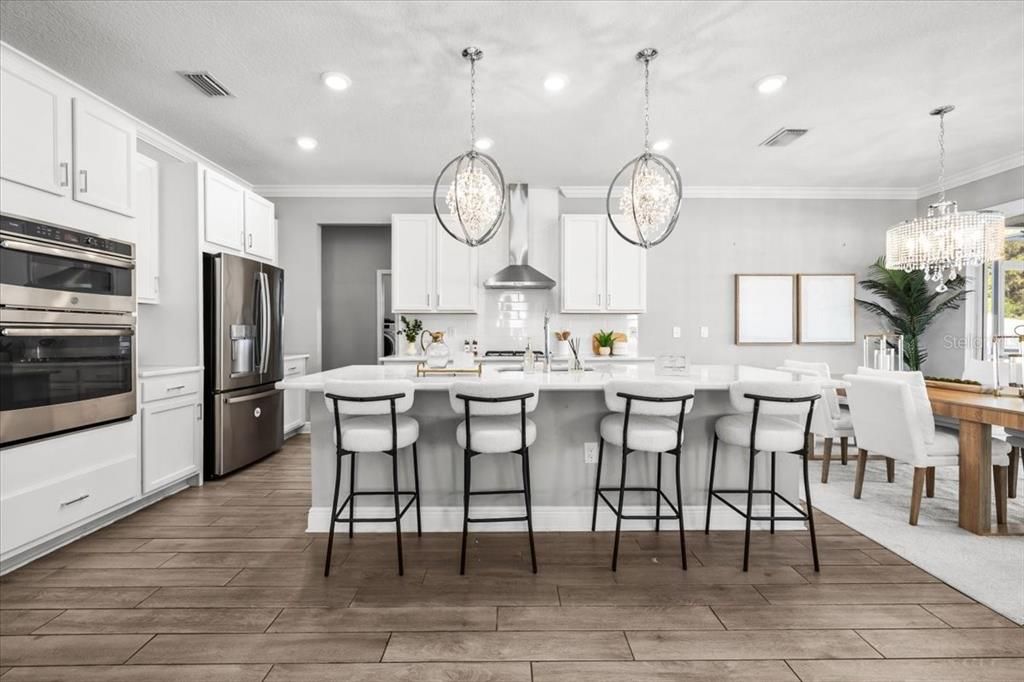 Chandelier, Dining room, Interior, Kitchen, Pendant Lights, Recessed Lighting, Stainless Steel Appliances, Wood Texture Flooring