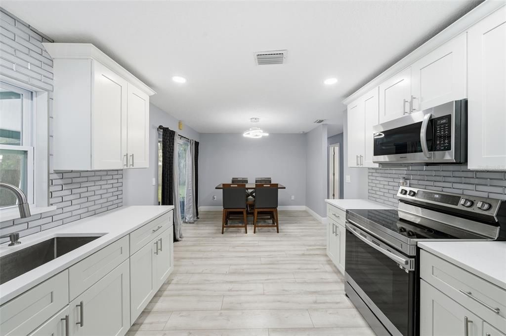 Dining room, Interior, Kitchen, Recessed Lighting, Stainless Steel Appliances, Wood Texture Flooring