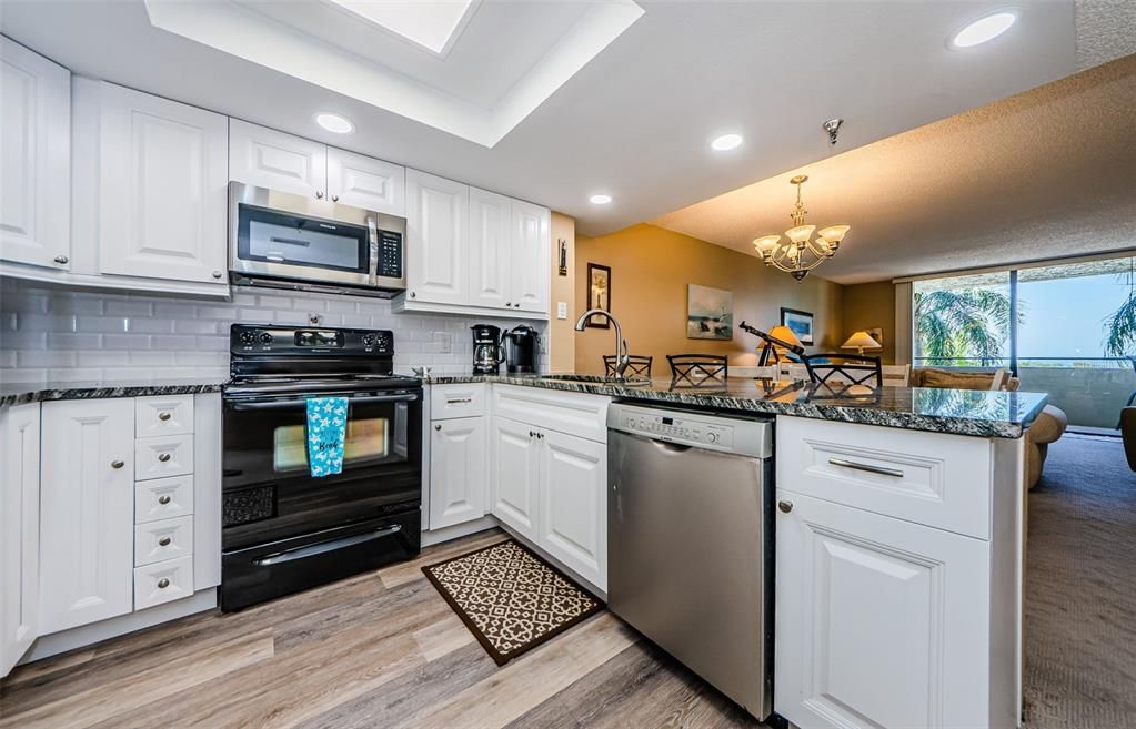 Chandelier, Dining room, Interior, Kitchen, Recessed Lighting, Stainless Steel Appliances, Wood Texture Flooring