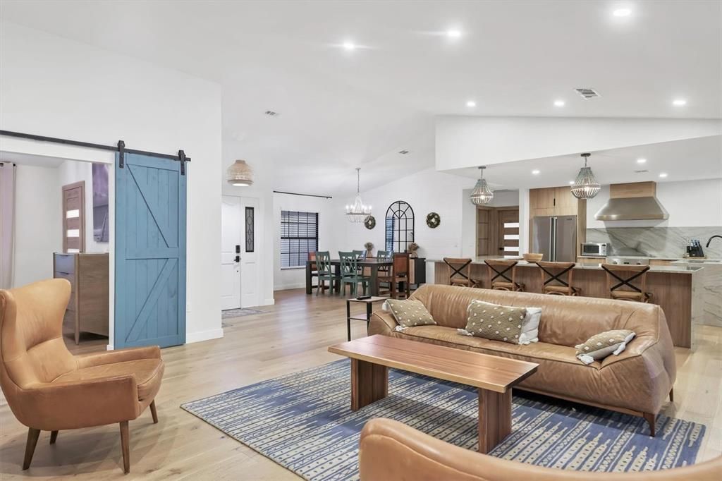 Chandelier, Dining room, Interior, Kitchen, Living room, Pendant Lights, Recessed Lighting, Stainless Steel Appliances, Wood Texture Flooring