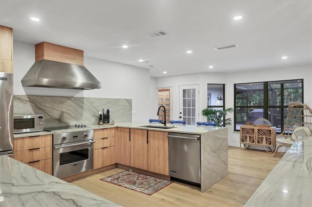 Interior, Kitchen, Marble Walls, Recessed Lighting, Stainless Steel Appliances, Wood Texture Flooring