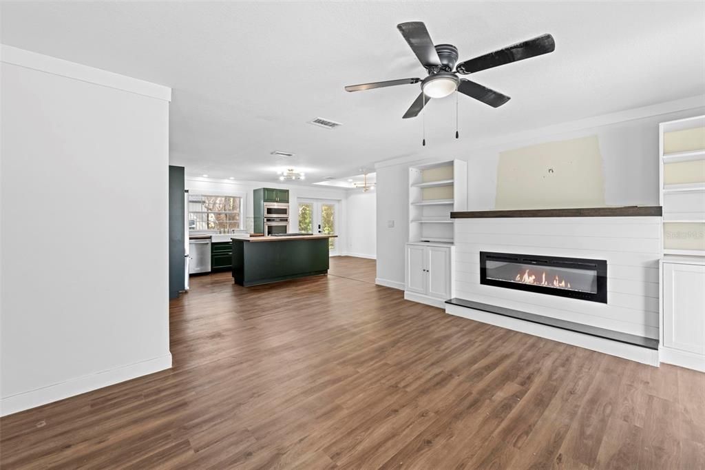 Empty room, Fireplace, Interior, Kitchen, Recessed Lighting, Wood Texture Flooring