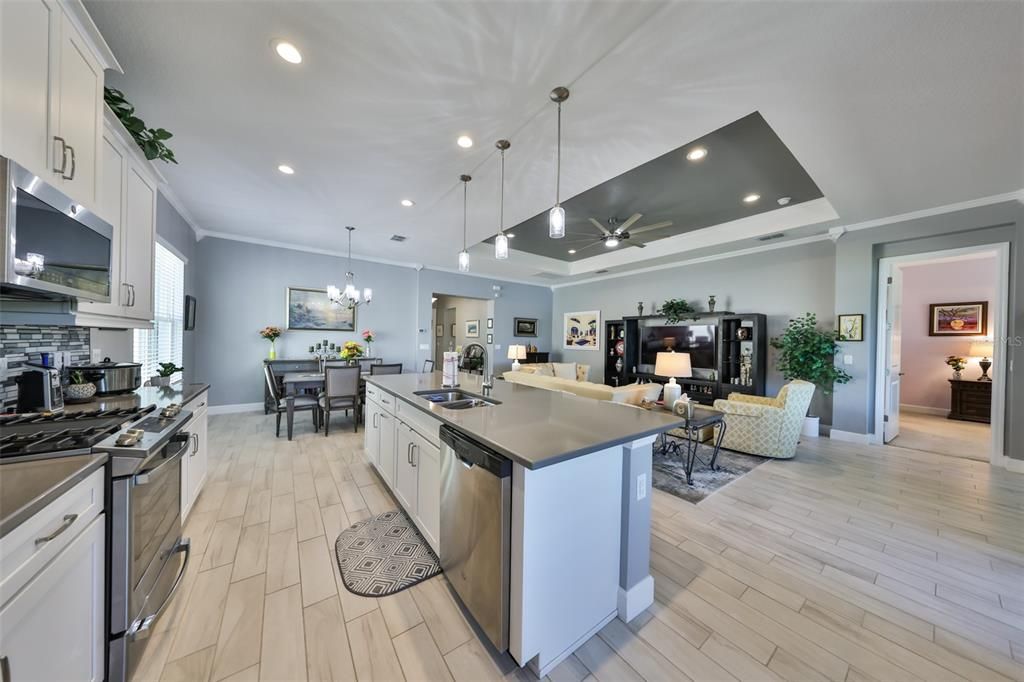 Chandelier, Dining room, Interior, Kitchen, Living room, Pendant Lights, Recessed Lighting, Stainless Steel Appliances, Wood Texture Flooring