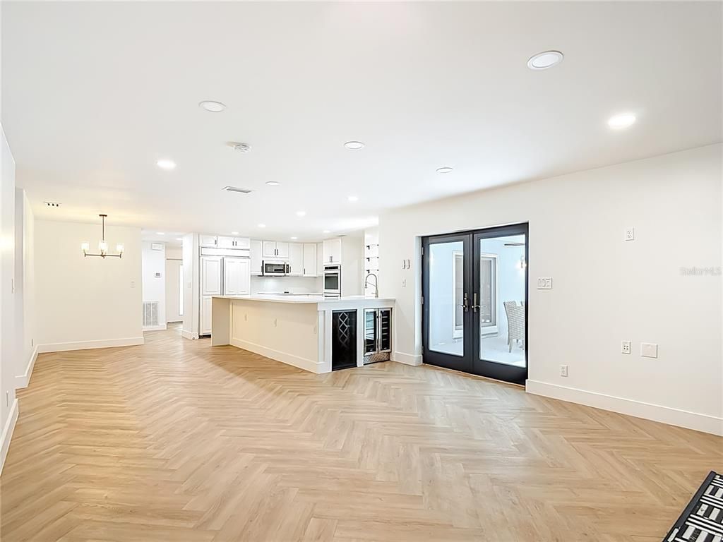 Empty room, Interior, Kitchen, Pendant Lights, Recessed Lighting, Stainless Steel Appliances, Wood Texture Flooring