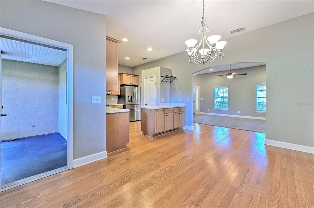 Chandelier, Empty room, Interior, Kitchen, Recessed Lighting, Stainless Steel Appliances, Wood Texture Flooring
