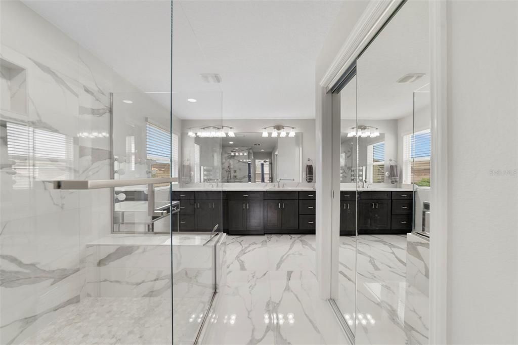 Bathroom, Chandelier, Dual Sink Vanities, Glass Shower, Interior, Marble, Marble Walls, Pendant Lights, Recessed Lighting