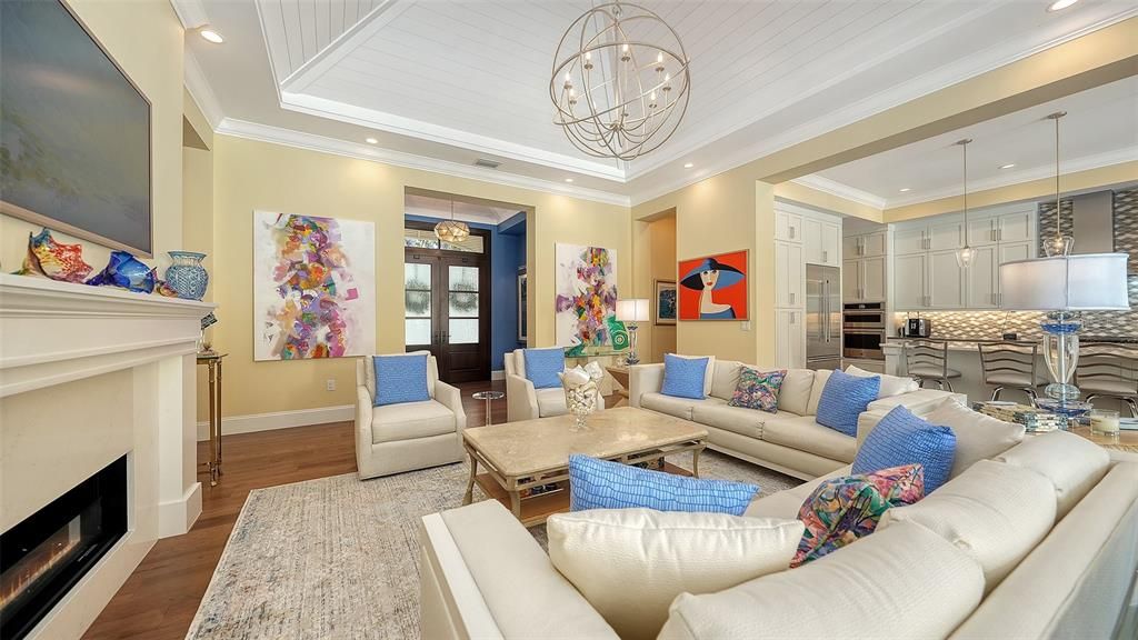 Chandelier, Fireplace, Interior, Kitchen, Living room, Pendant Lights, Recessed Lighting, Stainless Steel Appliances, Wood Texture Flooring