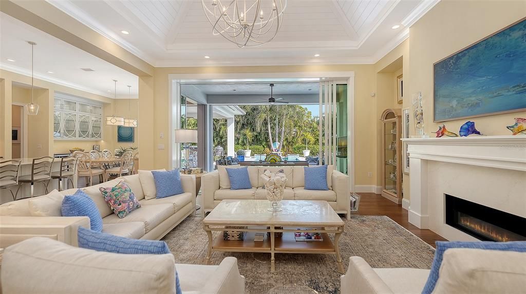 Chandelier, Dining room, Fireplace, Interior, Living room, Pendant Lights, Recessed Lighting, Wood Texture Flooring