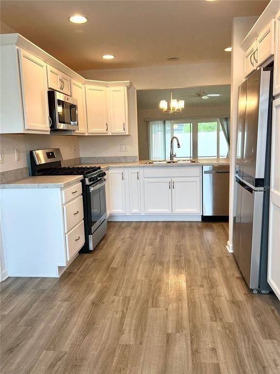 Chandelier, Interior, Kitchen, Recessed Lighting, Stainless Steel Appliances, Wood Texture Flooring