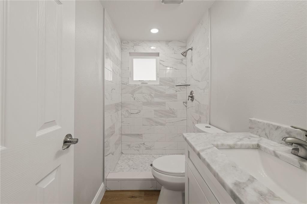 Bathroom, Glass Shower, Interior, Marble Walls, Recessed Lighting, Wood Texture Flooring