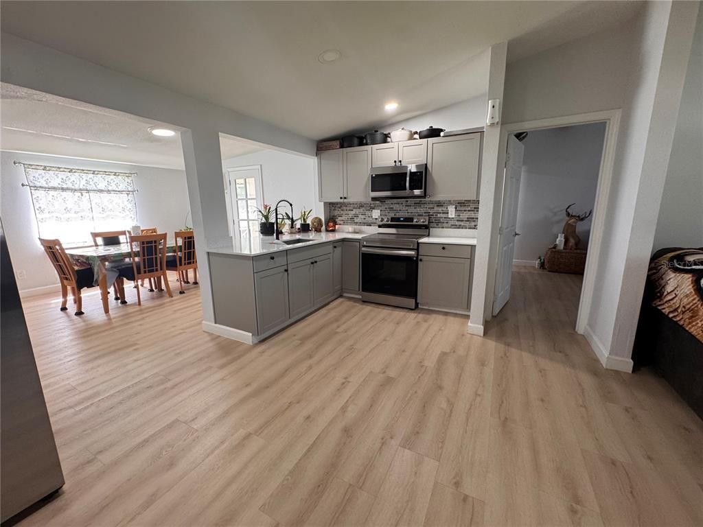 Dining room, Interior, Kitchen, Recessed Lighting, Stainless Steel Appliances, Wood Texture Flooring