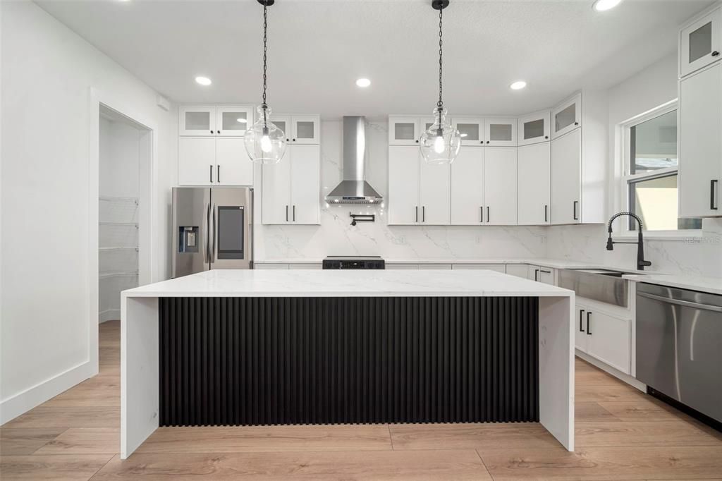 Interior, Kitchen, Marble Walls, Pendant Lights, Recessed Lighting, Stainless Steel Appliances, Wood Texture Flooring