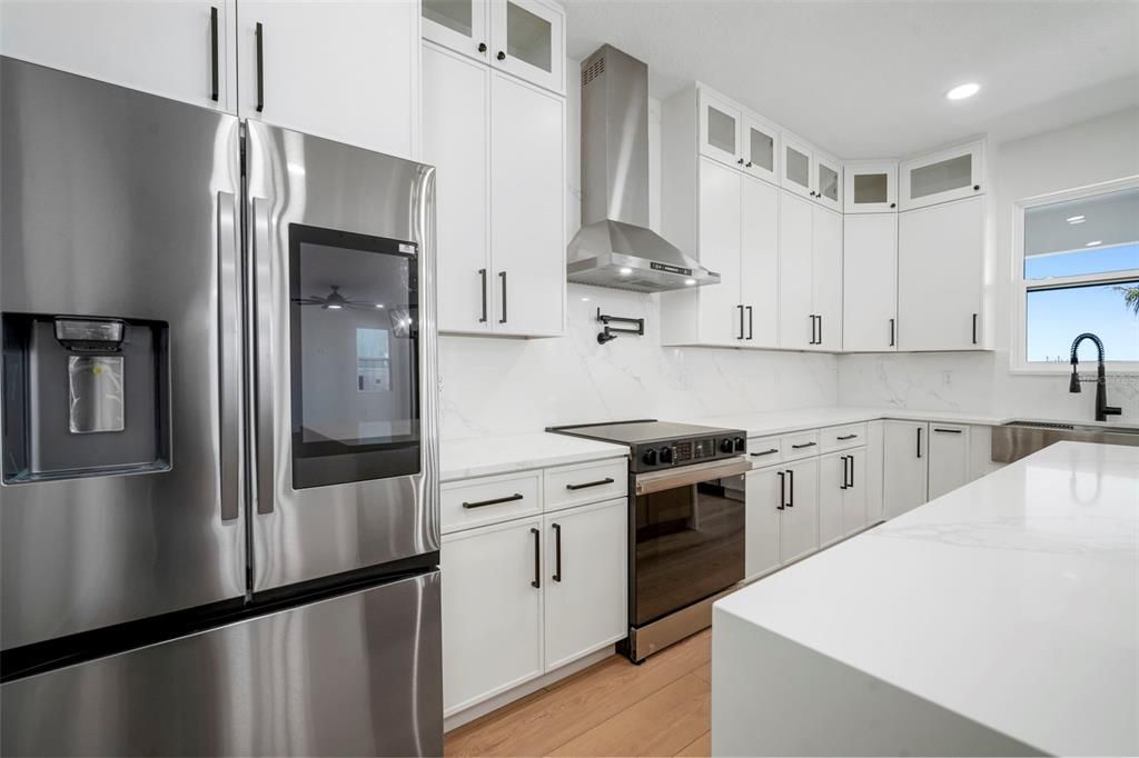 Interior, Kitchen, Marble Walls, Recessed Lighting, Stainless Steel Appliances, Wood Texture Flooring