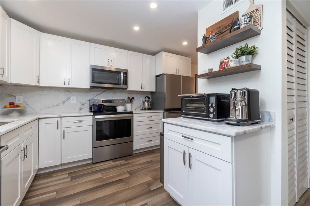 Interior, Kitchen, Marble Walls, Recessed Lighting, Stainless Steel Appliances, Wood Texture Flooring