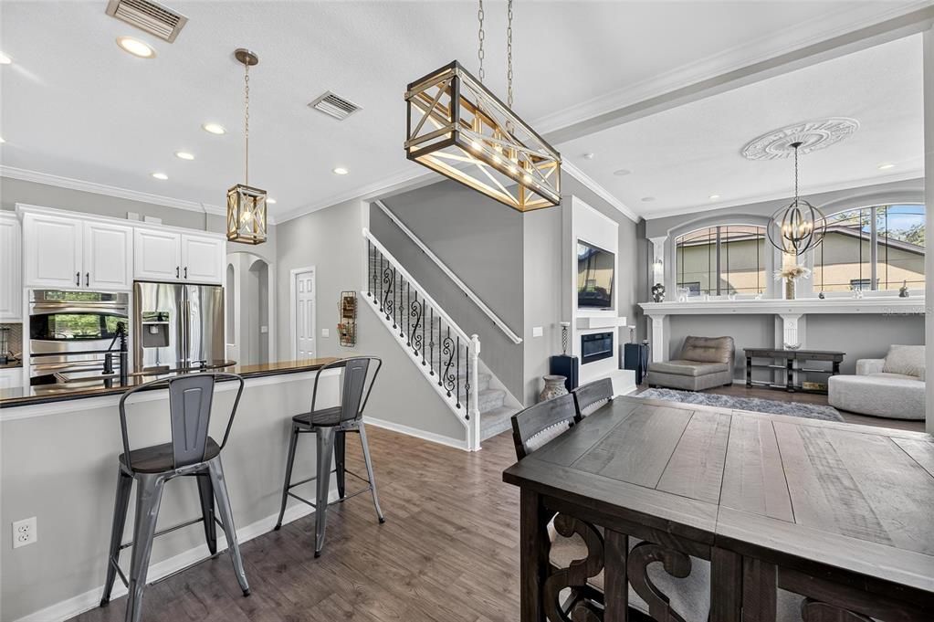 Chandelier, Fireplace, Interior, Kitchen, Pendant Lights, Recessed Lighting, Stainless Steel Appliances, Wood Texture Flooring