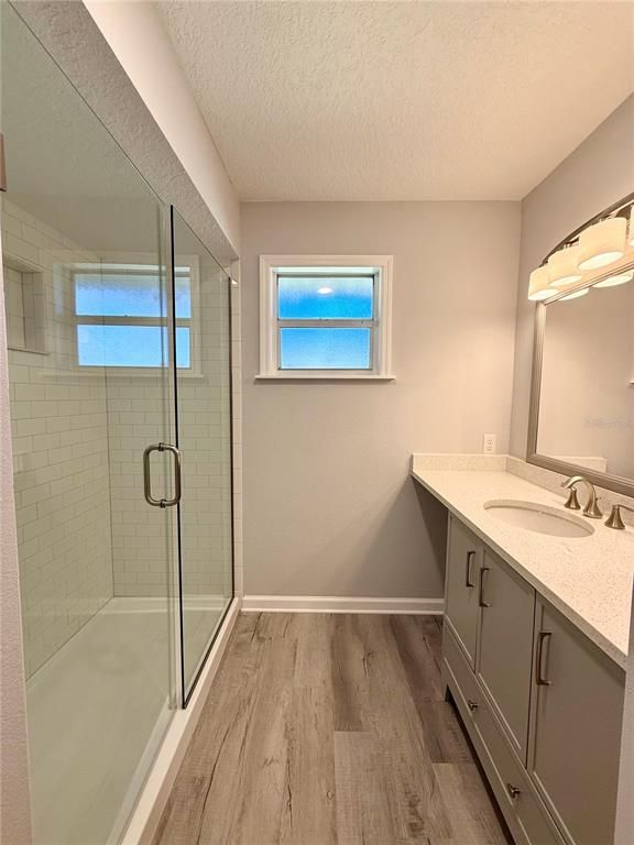 Bathroom, Dual Sink Vanities, Glass Shower, Interior, Wood Texture Flooring
