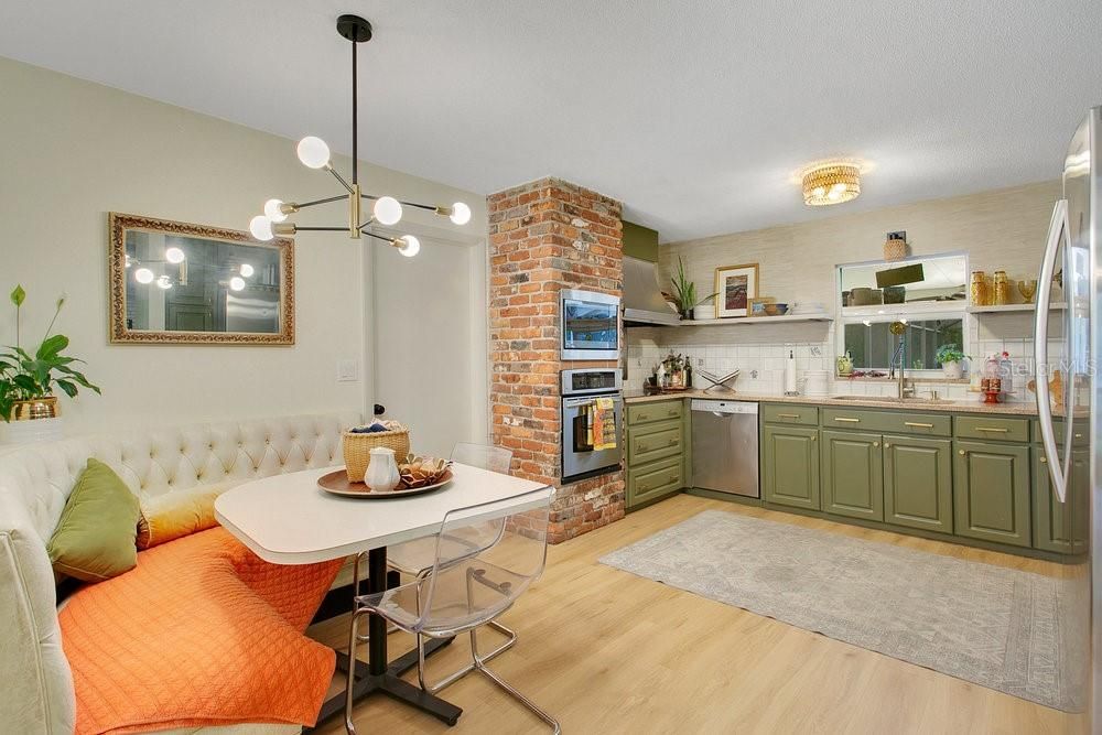 Dining room, Fireplace, Interior, Kitchen, Pendant Lights, Stainless Steel Appliances, Stone Walls, Wood Texture Flooring