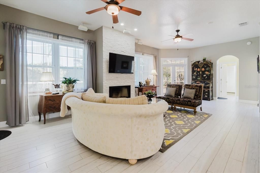 Fireplace, Interior, Living room, Recessed Lighting, Stone Walls, Wood Texture Flooring