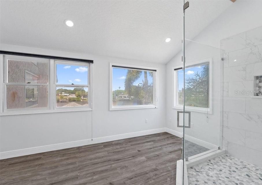 Bathroom, Empty room, Glass Shower, Interior, Marble Walls, Recessed Lighting, Wood Texture Flooring
