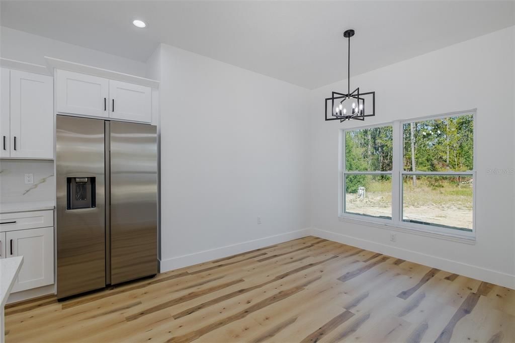 Empty room, Interior, Pendant Lights, Recessed Lighting, Stainless Steel Appliances, Wood Texture Flooring