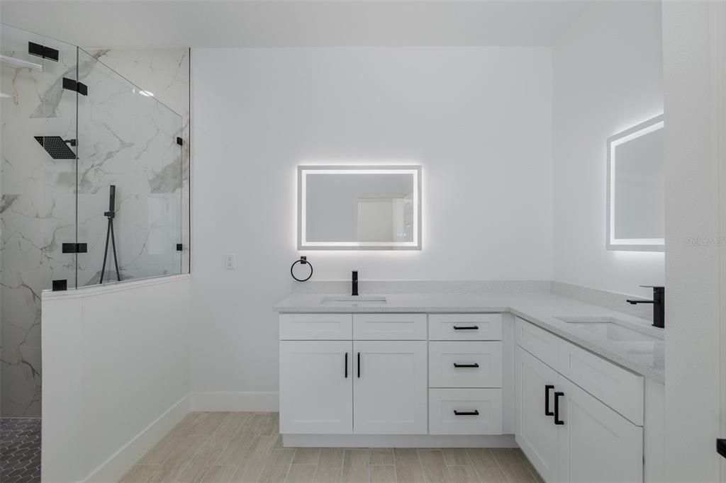 Bathroom, Dual Sink Vanities, Glass Shower, Interior, Marble Walls, Wood Texture Flooring