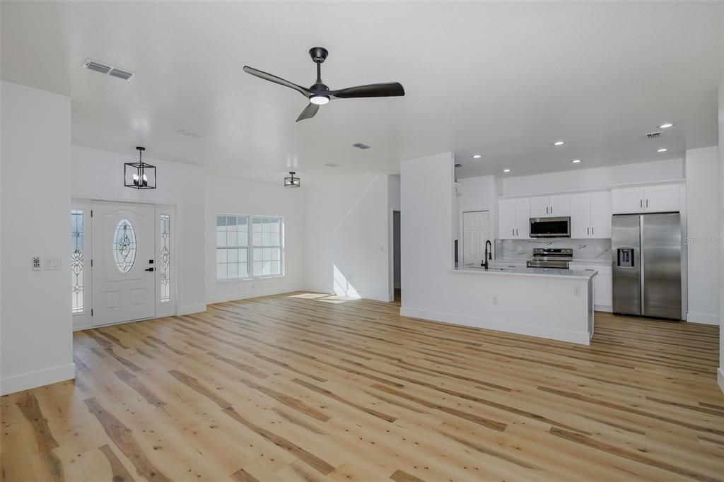 Empty room, Interior, Kitchen, Pendant Lights, Recessed Lighting, Stainless Steel Appliances, Wood Texture Flooring